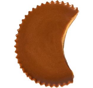 A chocolate peanut butter cup with a bite taken out